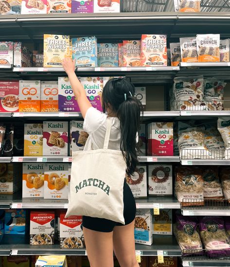 Girl reaches upwards for a box of cereal in the cereal aisle of the grocery store. She shows off her canvas tote bag that says "Matcha Monster" Canvas Tote Bag Aesthetic, Matcha Aesthetic, Baby Tote Bag, Aesthetic Tote Bag, Tote Bag Aesthetic, Aesthetic Bags, Cute Cafe, Bag Aesthetic, Bags Aesthetic