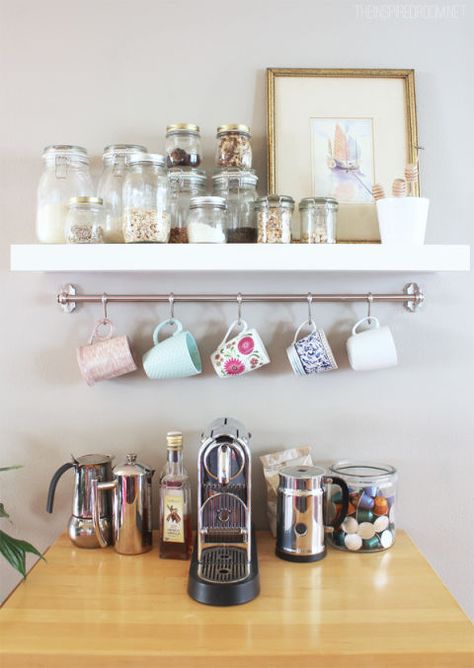 When you combine a floating shelf with a silver rail and S-hooks, you have a coffee station that feels almost like a brand-new piece of furniture. Click through for more on this and other ways to organize your coffee cups and mugs. Adulting Aesthetic, Coffee Mug Storage, Diy Coffee Station, Apartment Things, Coffee Station Kitchen, Mug Storage, Tea Station, Coffee Bar Design, Ikea Design