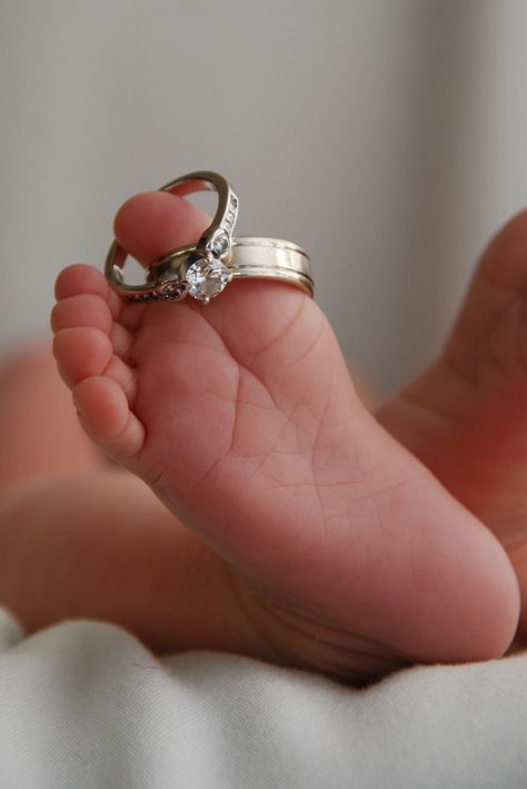 Newborn photo with wedding rings. Wedding Ring Newborn Photo, Newborn Photos With Wedding Rings, Wedding Photos With Infant, Newborn Photo With Wedding Dress, Sadie Photoshoot, Ring Photoshoot, Newborn Photo Ideas, Wedding Ring Pictures, Baby Boy Shower Party