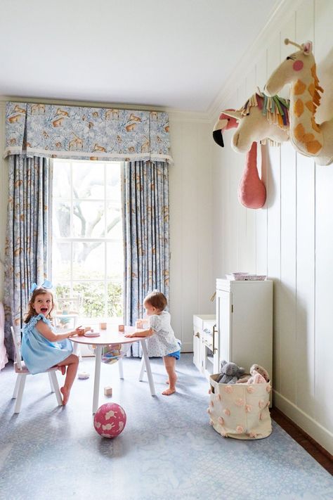 Amy Berry Designed Dallas Home White Playroom with Blue Accents and Stuffed Animals on the Wall Traditional Playroom, Grey Striped Wallpaper, Kids Playroom Design, Cream Cabinet, Amy Berry, Dark Brown Walls, Montessori Board, Playroom Makeover, Toy Storage Ideas