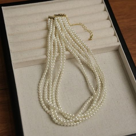 This elegant 5-layer twist style pearl necklace is a masterpiece of design, combining the timeless beauty of pearls with a modern twist. The multi-layered strands create a rich and textured look that drapes gracefully, making it an ideal accessory for weddings, formal events, or elevating everyday attire. #rosycozy #vintagejewellery #pearlnecklace #vintagestyle #elegant #pearl #audreyhepburn Old Money Pearl Necklace, Multi-strand Layered Pearl Chain Necklace For Parties, Elegant Multi-strand Pearl Layered Necklace, Gold Pearl Multi-strand Layered Necklace, Luxury Pearl White Vintage Necklace, Style Pearl Necklace, Layered Pearl Necklace, Wedding Bride Jewelry, Twist Style