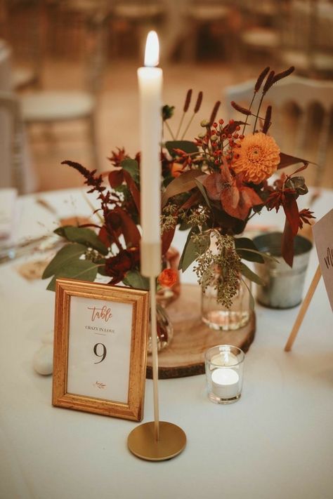 Rustic Fall Wedding Table Numbers, Wedding Amber Glassware, Wedding Florals Terracotta, Rustic Farm Wedding Table Decor, Eclectic Fall Wedding Decor, Dusty Fall Wedding Colors, Terracotta And Blue Centerpieces, Simple Autumn Centerpieces, Sunset Terracotta Wedding Centerpieces