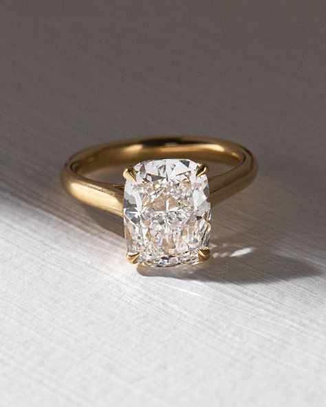 Heres a Micro Trend we noticed... or is it macro? 💍 📈 Elongated Cushion cuts! Whats the big deal? They have been spotted on A-listers like Kim Kardashian and Victoria Bekham but why not just wear a traditional cushion cut diamond, like Megan Markle did? We think they have gained recent popularity because they are the sweet middle spot between the gorgeous elongated shape of an oval cut (we all love) and the crushed ice brilliance of a radiant cut. The ratio that makes these so desirable... 4 Carat Asscher Engagement Ring, Thick Band Engagement Rings, Unique Cushion Cut Engagement Rings, Elongated Cushion Cut Engagement Ring, 2mm Wedding Band, Unique Solitaire Engagement Ring, Commitment Ring, Engagement Aesthetic, Thick Gold Band