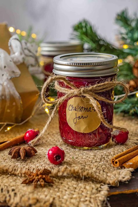 This Sweet Christmas Jam is a festive blend of tangy cranberries, sweet strawberries, and warm holiday spices that capture the essence of the season. Perfect as a thoughtful homemade gift or a delicious addition to your holiday appetizers, this jam is bursting with flavor and holiday cheer. Spiced Christmas Jam Recipes Homemade, Christmas Spice Jam, Jam Gift Basket Ideas, Jam Gift Basket, Spiced Christmas Jam, Holiday Jam, Christmas Chutney, Gathering Recipes, Jam Gift