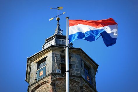 We know the Dutch flag is red, white and blue, but what does the Netherlands flag mean? Why isn't orange in there? We've got everything you need to know. Bicycle Friendly Cities, Dutch Phrases, Mark Rutte, Dutch Flag, Netherlands Flag, Dutch People, Dutch Language, Uk Visa, Prime Minister