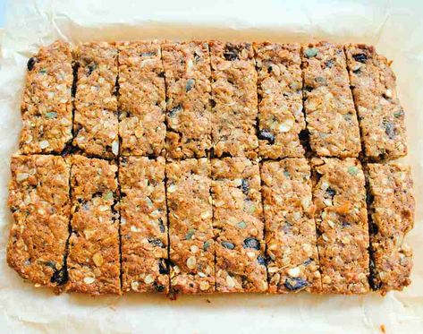 Healthy homemade cereal bars made with oats and plenty of dried fruit and seeds. Cereal bars or granola bars? Either way they are much better than shop-bought bars. Oat And Fruit Bars, Oat Fruit Bars, Oat Cereal Bars, Dried Fruit Granola Bars, Dried Fruit Uses, Baked Cereal Bars, Cereal Bars Recipes Healthy, Dried Fruit Bars, Muesli Bars Recipe