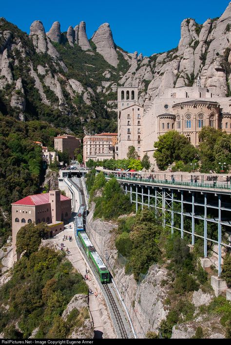 The Benedictine Monastery at Montserrat is served by a 5km (3.1 miles) metre gauge rack railway operated by the Ferrocarril de la Generalitat de Catalunya (FGC) from Monistrol de Montserrat station in the valley below. This 4-car train has just left the station at Montserrat, situated under the car park, and is heading downhill to the valley 550m (1804 ft) below. Montserrat Spain, Montseratt Spain, Spain Places To Visit, Ronda Spain, Catalonia Spain, Spain Photography, Spain Holidays, Spain Travel, Travel Inspo