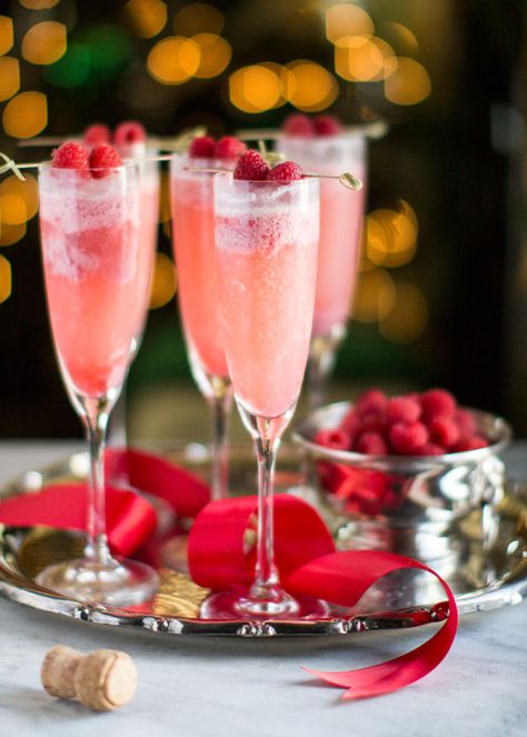 Frozen raspberries, sugar, heavy cream, and champagne combine for a fresh drink with colors that pay homage to Saint Nick.  Get the recipe at The Stier Aesthetic. Christmas Drinks Alcohol, Weihnachtlicher Cocktail, Best Christmas Cocktails, Christmas Cocktails Easy, Mimosa Recipe, Wedding Toast, Raspberry Cream, Christmas Cocktail, Fresh Drinks