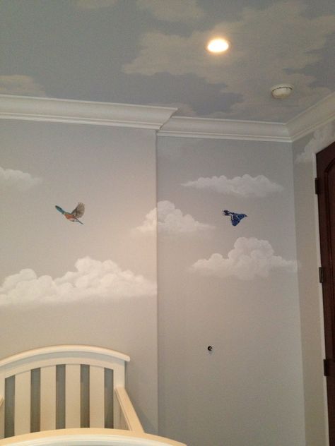 Our finished nursery! This is a shot of our light grey walls and light blue ceiling, all accented by beautiful clouds and birds. Amazing mural work from Katie Gaines @lovepaperpaint !! We are so in love! #genderneutral #tree #bird #mural #baby #clouds Nursery Sky Ceiling, Nursery Cloud Wall, Ceiling Clouds Painting, Bird Themed Nursery, Light Blue Ceiling, Cloud Ideas, Cloud Project, Cloud Mural, Nursery Ceiling