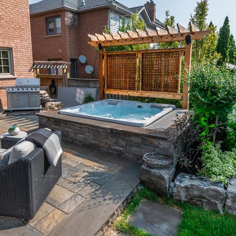 Surrounding your hot tub with a stone wall is a great way to give your backyard a premium look Backyard Patio Designs Hot Tubs, Retaining Wall Hot Tub, Hotub Ideas Patio, Swim Spa Privacy Ideas, Multilevel Deck With Hot Tub, Hot Tub With Privacy Wall, Hot Tub Next To House, Hot Tub Privacy Wall, Jaccuzi Outdoor Backyards