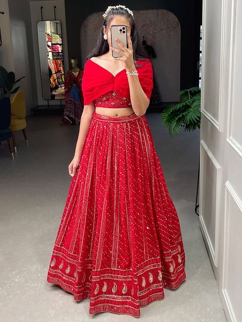 Introducing our appealing red sequins georgette party wear crop top lehenga! This exquisite outfit is designed to make you look absolutely stunning and steal the spotlight at any event. With its vibrant red color and intricate sequins and embroidery threadwork all over, this lehenga will showcase your impeccable taste and style. This lehenga is its red color georgette material, which adds a touch of elegance and sophistication to the overall design. The sequins and embroidery threadwork further Simple Party Wear Skirt And Top, Red Lehenga White Blouse, Red Blouse Designs For Lehenga, Choli Styles For Lehenga, Trendy Lehenga Blouse Designs, Trendy Crop Tops For Lehenga, Red Lehenga Blouse Designs, Latest Party Wear Dress 2024, Red Traditional Dress Indian