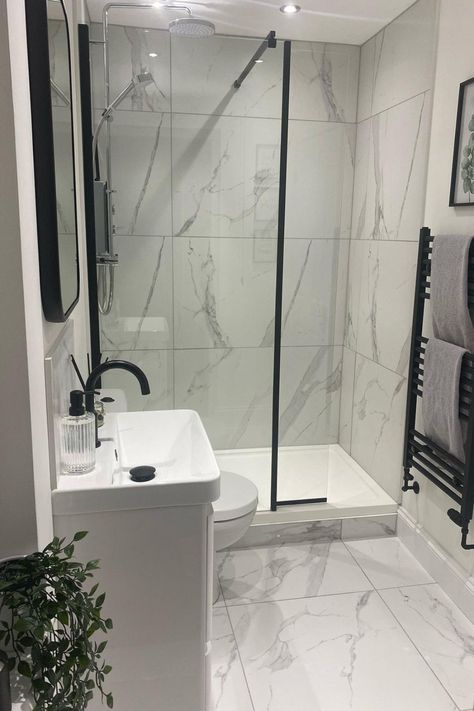 White Marble Ensuite, White Bathroom Black Accessories, Grey And White Bathroom With Black Fixtures, Grey Bathroom Black Accessories, White Marble Bathroom Accessories, Bathroom Inspiration Black And White, Black And White Shower Room Ideas, White Marble Bathroom With Black Accents, Small Monochrome Bathroom