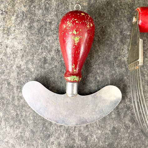 Seven vintage kitchen essentials of mixed ages and conditions. Includes: Foley 3 blade chopper, has some rust spots Small mezzaluna knife with chippy paint handle Melon baller with red handle Aluminum egg slicer Heuck butter cutter, one of the wires has a bend Androck red handle pastry blender A&J bowl hand mixer with green knob CONDITION All vintage. All well used. We did a general cleaning, but you'll need to do some detail cleaning to put these guys into use. It will be worth it. We priced it Antique Kitchen Tools Decor, Vintage Kitchen Tools Display, 1910 Kitchen, Antique Kitchen Utensils Metal, Antique Kitchen Utensils Ceramic, Vintage Utensils, Set Of Tools Vintage, Antique Kitchen Utensils, Egg Slicer