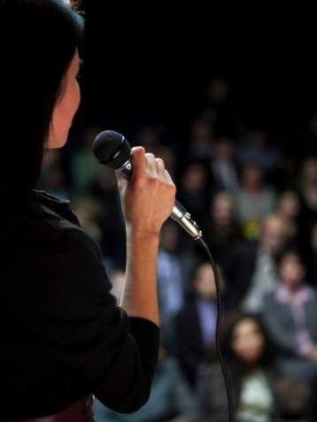 woman-public-speaking Speaking To An Audience, Speaking To Audience, Public Speaker Vision Board, Speak On Stage, Public Speaking Vision Board, Woman On Stage Speaking, Woman Speaker Public Speaking, Vision Board Public Speaking, Woman Speaker Aesthetic