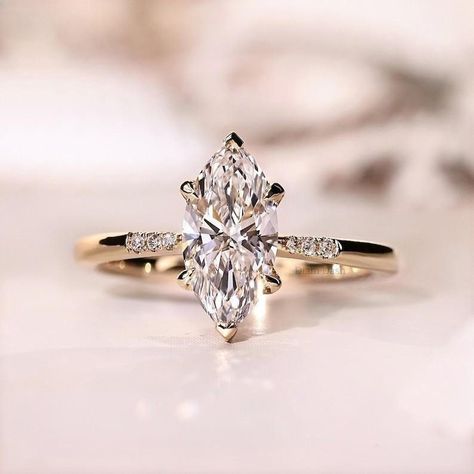 Elegant Marquise Diamond Ring in Yellow Gold - Moissanite Diamond Engagement Ring, V Shaped Prongs, Gifts for Her ✥ YOUR PURCHASE WILL INCLUDE ↣ Free Shipping ↣ Free Ring Sizing ↣ Free Ring Box ↣ Free Gift Box Wrapping ↣ Free Engraving ↣ 100% Satisfaction 𝐌𝐨𝐢𝐬𝐬𝐚𝐧𝐢𝐭𝐞 𝐢𝐬 𝐝𝐢𝐚𝐦𝐨𝐧𝐝𝐬 𝐛𝐞𝐬𝐭 𝐚𝐥𝐭𝐞𝐫𝐧𝐚𝐭𝐢𝐯𝐞. 𝐑𝐢𝐧𝐠 𝐃𝐞𝐭𝐚𝐢𝐥𝐬 * Metal Purity: Solid Gold (10k / 14k / 18k),Platinum 925 Sterling Silver * Metal Tone: White / Rose / Yellow * Stamp / Hallmarked: Yes Customization * Diamond: Natural Diamond / Moissanite / CVD -Lab Grown / Cubic Zirconia ● 𝐂𝐞𝐧𝐭𝐞𝐫 𝐒𝐭𝐨𝐧𝐞 𝐃𝐞𝐭𝐚𝐢𝐥𝐬:- → Center Stone Shape : Marquise Cut Moissanite → Center Stone Size: 2.55CT → Center Stone Measurement: 7x14 MM → Stone Color: Colorless → Stone Clarity: VVS → Mohs Scale : Moiss Marquise Vintage Engagement Ring, Oval Bridal Set, Diamond Centerpiece, Marquise Diamond Engagement Ring, Marquise Diamond Ring, Lab Grown Diamond Engagement Ring, Cute Engagement Rings, Wedding Band Designs, Engagement Rings Marquise