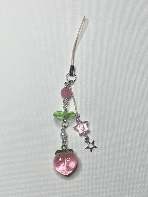 Peach, beads, glass bleads, phone charm, wired, charms, aesthetic, handmade, stars, leaf, peaches Sawako Phone Charm, Phone Charm Ideas, Aesthetic Phone Charms, Phone Charms Aesthetic, Charms Aesthetic, Handmade Stars, Emo Accessories, Charm Ideas, Diy Beaded Rings