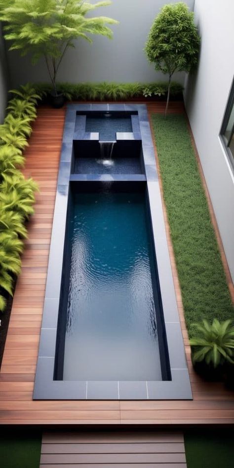 Utilize the length of your small yard by incorporating a slim, elongated plunge pool. This design leaves ample space for decked areas and lounging, making it an efficient and stylish solution for narrow outdoor spaces. Narrow Backyard Pool, Lap Pool Designs Small Yards, Narrow Pool Small Yards, Small Yard With Pool, Lap Pools Backyard Small Yards, Plunge Pools For Small Yards, Small Plunge Pools For Small Yards, Small Space Pool, Overground Pool