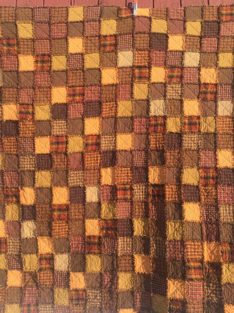 "This lovely quilt was inspired by the beauty of the Autumn colors we see every Fall in our remote mountain setting. I selected  about 20 different woven cotton homespun fabrics in browns, golds, oranges and red plaids/checks to construct this queen sized bed quilt. Using the \"rag quilt\" technique and a random design placement of the blocks gives this beauty a country/farmhouse, rustic/ primitive charm.  Each block has the traditional \"X\" quilted through it and is the same fabric on both sid Autumnal Quilt, Fall Quilts Autumn, Warm Colors Aesthetic, Salsa Aesthetic, Quilt Aesthetic, Quilt Background, Patchwork Aesthetic, Brown Quilt, Autumn Quilt