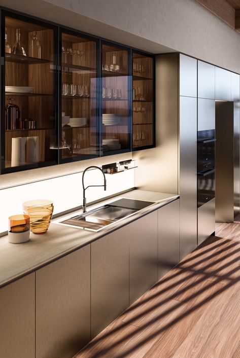 On the backsplash is the K Panel, which illuminates the counter space and is fitted to store small frequently-used items. On the left, the tall units incorporate pivot doors that hide the wet kitchen or pantry area. Nara, Wet Kitchen, Aluminum Kitchen Cabinets, Pantry Interior, Metal Kitchen Cabinets, Tall Kitchen Cabinets, Italian Kitchen Design, Glass Kitchen Cabinet Doors, Tall Pantry Cabinet