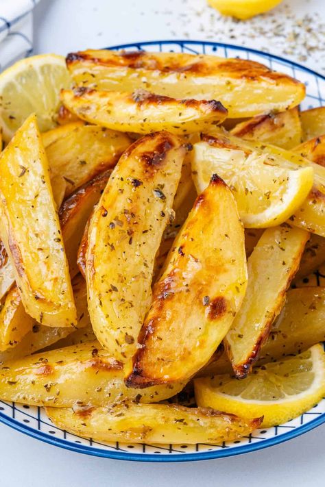 These Greek Lemon Potatoes aren't your regular potatoes. Roasted in a lemony broth, they're soft and tender with crispy edges. This is a side dish to impress! Greek Lemon Potatoes Recipes, Greek Potatoes Easy, Greek Roast Potatoes, Greek Baked Potatoes, Greek Style Lemon Roasted Potatoes, Best Greek Potatoes, Authentic Greek Potatoes, Jimmy The Greek Potatoes, Easy Greek Potatoes Recipe