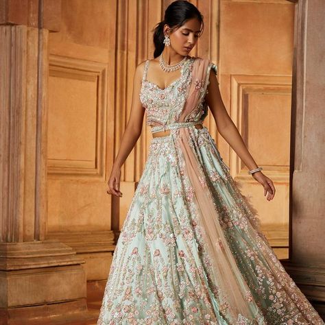 Nitika Gujral shared a post on Instagram: "This contemporary soft mint green tulle Lehenga set paired with a worked belt and a blush pink dupatta embroidered in a baroque floral pattern in tonal and contrast beads, sequins and crystals has a youthful elan! ——— Jewellery: @shriramhariramjewellers Styling and creative direction: @ayeshaaminnigam Photographer: @hormisantonytharakan HMU: @makeupkomal @aamirkhan_hairstylist Videographer: @studio36 Models: @husnbano6 Assistant stylist: @... Sage Green And Pink Lehenga, Sage Green Mehndi Outfit, Sage Lengha, Sage Green Wedding Dress For Bride, Sage Green Indian Outfit, Sage Green Lengha, Pink And Green Lehenga, Crystal Lehenga, Pretty Lehengas