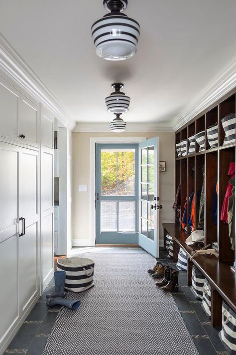 lighting Long country style mudroom features a wall lined with open stained mudroom lockers accented with rugby stripe bins from the Container store both below each seat and above on the top of each shelf for extra storage and enhanced organization. Laundry/mudroom Ideas, Transitional Laundry Room, Farmhouse Mudroom, Laundry Room/mud Room, Mudroom Lockers, Mudroom Ideas, Mudroom Entryway, Mudroom Decor, Farmhouse Entryway