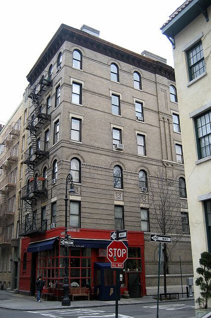 NYC - West Village: 90 Bedford Street (Friends House)    This building serves as the exterior for the apartment on Friends, although no scenes featuring cast members were filmed in New York. Even the famous opening was filmed around a fountain in a Hollywood studio. In real life, it is now home to The Little Owl, a Mediterranean-influenced eatery that replaced Chez Michaellet. Bedford Street, Friends Apartment, Places In Usa, Friends House, Movie Locations, Hollywood Studio, Film Locations, New York Hotels, New Amsterdam