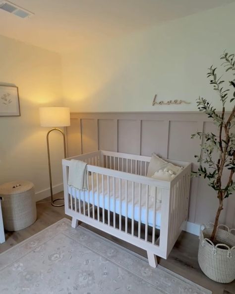 Thrilled to share a peek into this beautiful girl’s nursery featuring our custom wooden name sign above the crib! Interested in adding a personal touch to your nursery? Message me today to create your custom sign! Nursery design by @melissaaderue #NurseryDecor #BabyGirl #CustomSigns #NurseryInspo #HandcraftedWithLove #nurserynamesign #namesign #namesigns Wood Panel Accent Wall Nursery, Half Wall Paneling Ideas Nursery, Half Wall Nursery, Nursery Wall Molding, Wood Accent Wall Nursery, Nursery Wall Paneling, Board And Batten Nursery Wall, Nursery Wainscoting, Board And Batten Nursery