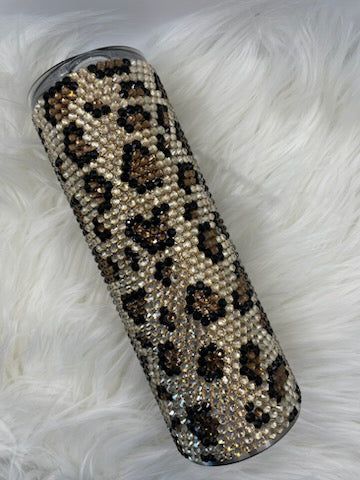 This 20 oz stainless steel tumbler with a Leopard print is an ideal accessory for any event. It is double wall vacuum insulated which will keep your drink hot or cold for an extended period of time. The exterior is adorned with shiny glass rhinestones for extra sparkle and shine. Make this fashionable tumbler your companion when you travel and you will be guaranteed a drink at the perfect temperature. Since each tumbler is crafted by hand and unique, please understand that there may be slight... Broken Arrow Oklahoma, Leopard Print Tumbler, Rhinestone Projects, Broken Arrow, Aaliyah, A Drink, Tumblers With Lids, Stainless Steel Tumbler, Cheetah Print