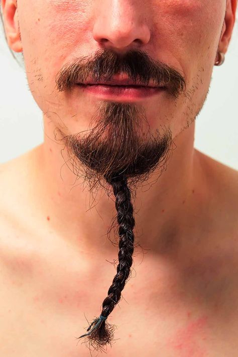 A braided beard is a trendy and modern way to style men facial hair that takes its origins from Vikings. From regular braids and twists to ponytails with beads, there are plenty of male Viking beard braid styles for men nowadays. #menshaircuts #menshairstyles #beardstyles #braidedbeard #beardbraid #vikingbeard Beard Trimming Styles, Long Mustache, Modern Viking, Braided Beard, Braid Styles For Men, Goatee Beard, Long Beard Styles, Beard Styles Short, Mustache Styles