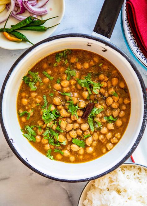 Chana masala! Indian chana masala, also called chole masala, is a vegetarian and vegan comfort food packed with flavor and perfect for dinner (or lunch) any day of the week! It also freezes beautifully, so works well as a make-ahead freezer meal. Break out your spices, and get cooking! #Indianfood #vegan #vegetarian #simplyrecipes #easychanamasala Indian Comfort Food, Chole Masala, Cooking Tomatoes, Meatless Mondays, Food Pack, Freezer Meal, Vegan Comfort Food, Masala Recipe, Turmeric Benefits