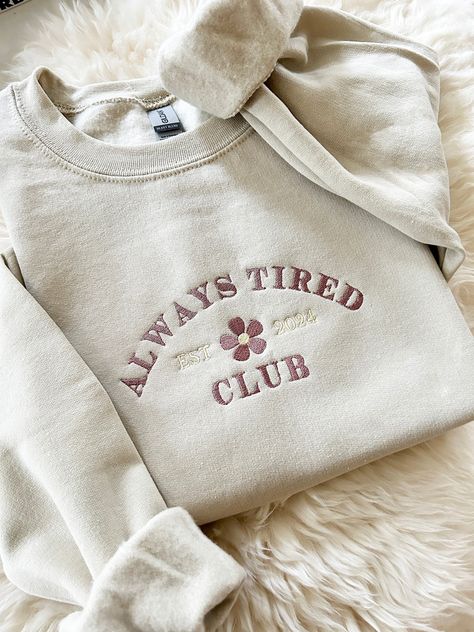 Embroidered Always Tired Club New Mom Gift Sweater - Embroidered - Unisex Crewneck Sweatshirt - Designed with pre-shrunk soft air-jet spun yarn - Loose fit for a comfortable feel * Sizing and Colors - Please refer to sizing and color charts in the images * Fabrication - 50% cotton, 50% polyester * Care Instructions - Turn inside out and machine wash cold on delicate cycle - Dry on low heat setting - Do not bleach - Do not dry clean - Do not iron directly on design * Processing and Shipping Times - Please allow 4-10 business days for your order to be processed and stitched - Standard shipping takes 3-5 days - Please note that these times are estimated by USPS and may take longer - Please make sure your shipping address is correct before placing an order - Stitched and Shipped in the USA * R Trending Crewneck Designs, Simple Embroidered Sweatshirt, Sweater Ideas Design, Iron On Sweatshirt Ideas, Embroided Hoodie, Etsy Sweatshirts, Outfit Ideas Shirt, Trendy Crewneck Sweatshirt, Cute Crewneck Sweatshirt