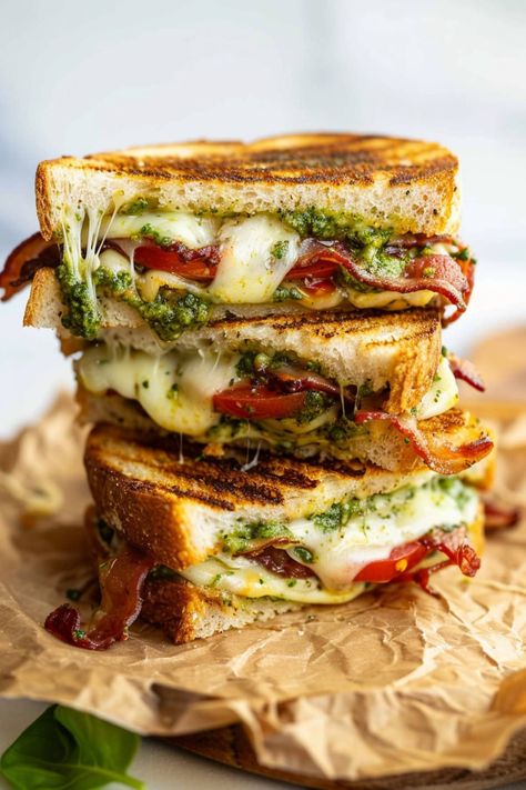 This pesto grilled cheese sandwich is a fun twist on an American classic. And it's so tasty, you might never make regular grilled cheese again! Grilled Cheese With Arugula, Caprese Grilled Cheese Sandwich With Pesto, Grilled Cheese With Meat Recipes, Best Grilled Sandwiches, Turkey Bacon Grilled Cheese, Grilled Cheese With Pesto, Grilled Ricotta Cheese Sandwich, Special Grilled Cheese Sandwich Recipes, Delicious Grilled Cheese