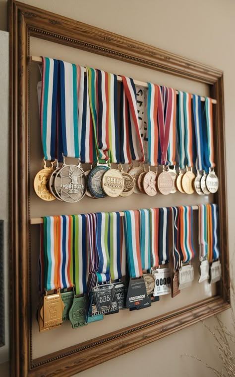 A combined display of race medals and bibs, neatly arranged on a large frame. Ways To Display Medals, Medal Display Ideas Diy, Diy Medal Display, Running Medal Display Ideas, Running Bib Display, Diy Medal, Race Bib Display, Display Medals, Medal Display Ideas