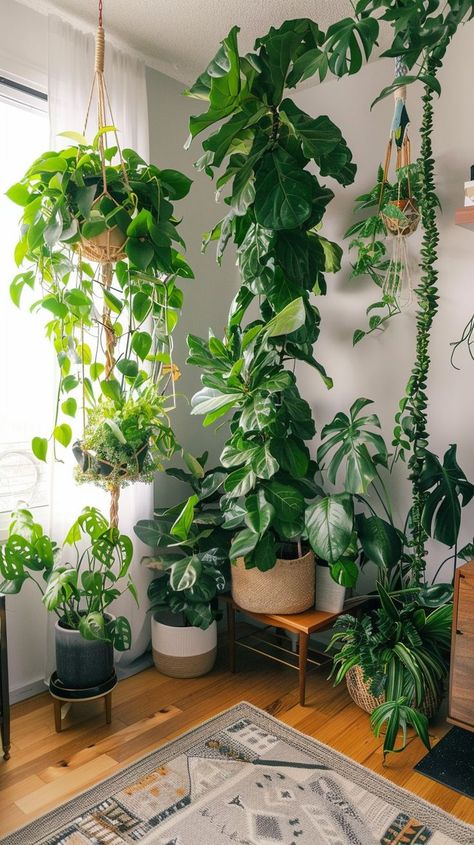 Indoor garden with tall leafy greens and small bushy plants in a bright room, creating a serene atmosphere. Home Jungle Houseplant, Vision Board Plants Aesthetic, Green House Plants Aesthetic, Home Aesthetic Plants, Modern Plant Interior Design, Plants Aesthetic Green, Aesthetic Rooms With Plants, House With A Lot Of Plants, Plant Room Ideas Aesthetic