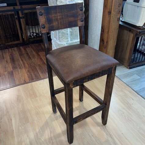 Our Ponderosa Barstool, crafted from premium quality textured pine wood. This barstool cushion is designed to provide a comfortable seating experience while adding a touch of rustic charm to your home decor. The cushion is expertly crafted to ensure durability and longevity, making it a perfect addition to any bar or kitchen counter. The textured pine wood finish adds a unique and natural aesthetic to the cushion, making it a standout piece in any setting. The cushion is easy to clean and mainta Cushioned Bar Stools, Farmhouse Counter Stools With Backs, Rustic Kitchen Bar Stools, Farmhouse Kitchen Barstools, Bar Height Bar Stools, Western Style Furniture, Farmhouse Barstools, Rustic Bar Stool, Shop Barstools