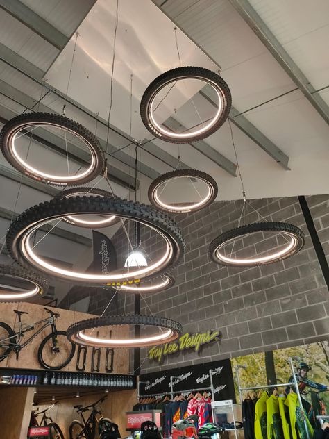 BESPOKE LIGHTS FIT FOR A NEW E BIKE SHOWROOM Workshop Decoration, Bike Showroom, Bike Room, Bicycle Store, Bicycle Decor, Pool Outdoor, Bicycle Shop, Wheel Chandelier, Showroom Interior Design