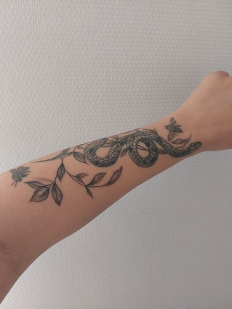 Snake And Flower Wrapped Around Arm Tattoo, Snake In Leaves Tattoo, Snakes And Vines Tattoo, Snake And Branch Tattoo, Snake And Wildflower Tattoo, Vines And Snake Tattoo, Vine And Snake Tattoo, Snake Olive Branch Tattoo, Olive Branch And Snake Tattoo