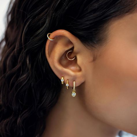 Most secure huggie earring has a hinge that is hidden when closed. Great for cartilage helix, tragus, rook, daith, septum and upper lobe piercings. 14K Gold Hypoallergenic, lead and nickel free Thickness 1mm, 18 gauge Endless Hoop Closure #JS010-G Hoops All The Way Up Ear, Cute Piercing Combinations, Detached Earlobe Piercings, Daith Hoop Piercing, Daith Piercing Hoop, Helix Hoop With Charm, Ear Piercings Upper Lobe, Gold Daith Piercing, Peircings Women Ear