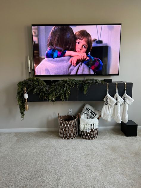 Christmas, christmas garland, tv stand, garland, greenery, Floating Tv Stand Christmas Decor, Stockings On Floating Shelf, Shelf Garland Christmas, Tv Console Garland Christmas, Garland Tv Stand Christmas, Tv Console Christmas Decor Garland, Christmas Decorations For Tv Stand, Christmas Console Table Decor Under Tv, Floating Mantle Christmas Decor