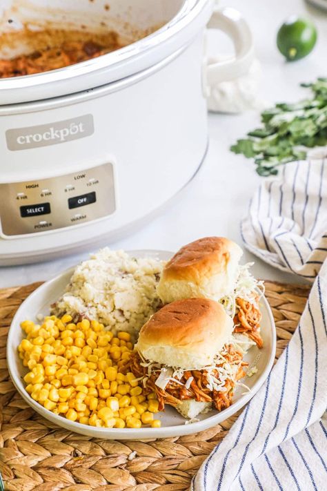 These Crockpot BBQ Chicken Sliders with Ranch Slaw are a total crowd pleaser! These Pulled BBQ Chicken Sliders made with a 3-ingredient slow cooker BBQ chicken piled onto sweet Hawaiian rolls, then topped with cabbage and Ranch dressing. These easy BBQ Chicken Sliders are perfect for summer potlucks, easy lunches or dinners, you name it. Serve as-is or enjoy the BBQ chicken in tons of other ways. This recipe is a total hit every time! Bbq Chicken Sliders Recipes, Ranch Slaw, Pulled Bbq Chicken, Sweet Hawaiian Rolls, Crockpot Bbq Chicken, Bbq Sliders, Easy Bbq Recipes, Sliders Recipes Chicken, Bbq Chicken Sliders