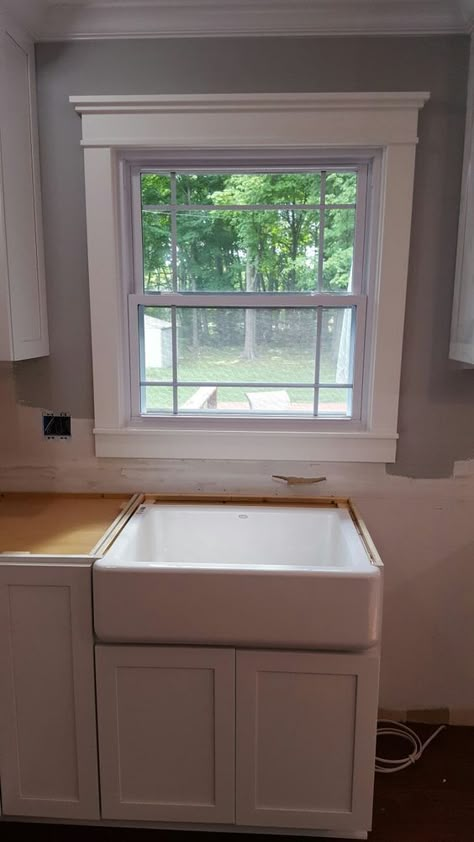 My new kitchen dream centered around a farmhouse apron sink. I chose this cast iron one by Kohler with a right side drain. I melted when I saw  it installed! The window was replaced with a modified prarie style, and replaced the "modern" trim with craftsman style molding. Bathroom Window Trim, Craftsman Molding And Trim, Craftsman Cottage Interiors, Craftsman Style Molding, Kitchen Remodel Farmhouse, Craftsman Window Trim, Craftsman Window, Small Bathroom Window, Window Over Sink