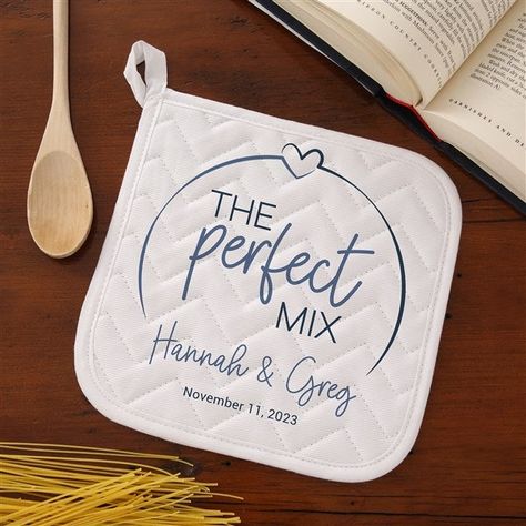 Personalize with names and line of textChoose from multiple colors White, cotton potholder features concentrated quilt patterns to keep the filling material evenly distributed, even after repeated washingsLined with silver acrylic coated cottonMeasures 8" x 8"Machine washSold IndividuallyImported Celebrate your new married status in the kitchen with our The Perfect Mix Personalized Apron & Potholder.  Makes a great bridal shower, wedding or anniversary gift! Personalized Kitchen Items, Potholders Cricut, Cricut Wedding Gifts, Personalized Pot Holders, Htv Pot Holder Ideas, Sublimation Pot Holders, Personalized Kitchen Towels Hand, Cricut Supplies, Cricut Wedding