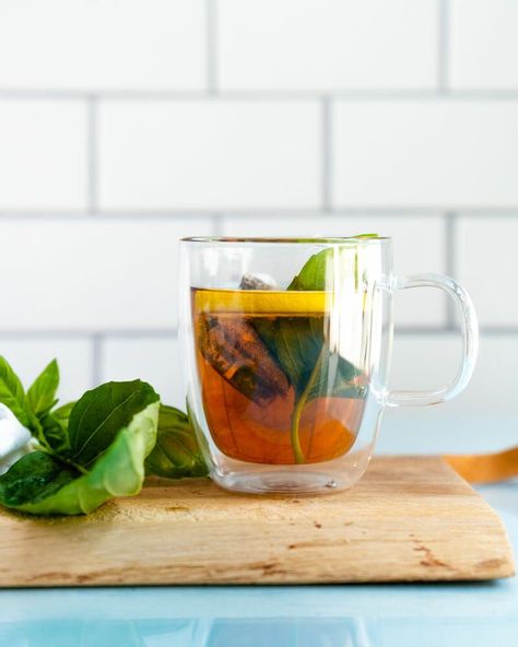 Here's how to make basil tea! This fresh herb infuses a beautifully subtle flavor into tea: add lemon for the perfect combination. Basil Tea Recipe, Making Herbal Tea, Harvesting Basil, Basil Tea, Ocimum Basilicum, A Couple Cooks, Tomato Basil Pasta, Growing Basil, Harvesting Herbs