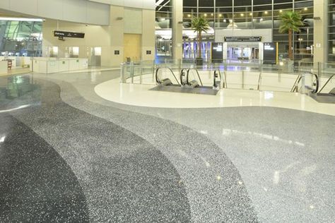 Terrazzo flooring is composed of composite material. It contains any variety of mixture of aggregate chips like stone or marble and either epoxy resin or concrete. It can be used both indoors and outdoors and can be poured as concrete or laid in tiles. Terrazzo Lobby, Terrazzo Flooring Pattern, Terrazo Flooring, San Diego Airport, Terazzo Floor, Building Lobby, Terrazzo Design, Airport Terminal, Airport Design