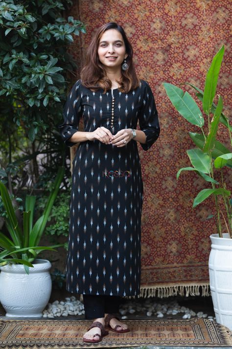 Tailored out of 100% premium cotton, arit is a poetry of elegance with its exquisite ikat print. The base is adorned with black ikat print giving a timeless monochromatic look. The smart front button round neckline, with 3/4sleeves, and functional pocket elevate its smartness. Pair it with our black cotton pants for a beautiful cohesive look. Black Cotton Kurti Design, Black Ikkat Kurti Designs, Ikat Suit Designs, Ikat Kurta Designs Cotton, Ikat Kurti Designs, Black Kurti Design, Kurti Neck Designs Latest Fashion, Plazo Kurti Design, Ikkat Kurti Designs