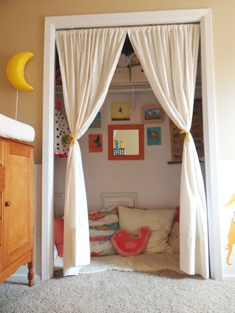 i love the curtains and the children's artwork on the wall :) Kids Closets Used as Reading Nooks Closet Nook, Reading Nook Closet, Zimmer Diy, Reading Nook Kids, Kids Closet, Shared Room, Kid Closet, غرفة ملابس, Open Door