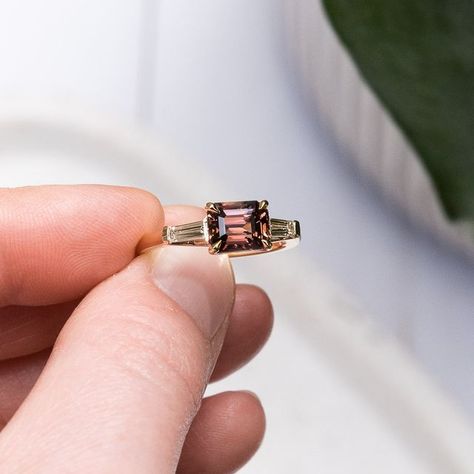 Teagan🔹Gemmologist + Designer on Instagram: "BESPOKE // CAMILLE + ADRIAN ​​​​​​​​ ✨ Emerald Cut Dusty Pink Rose Brown Madagascan 2.02ct Sapphire. ​​​​​​​​ ✨ 18k Yellow Gold Trilogy Setting ​​​​​​​​ ​​​​​​​​ We are obsessed with the unique style and colour of this ring! This is a east-west set, with the gem going across the finger rather than up. This gives us all the art-deco vibes we love, and we enjoyed making this one so much! 😍​​​​​​​​ ​​​​​​​​ #melbournejeweller #shoplocalmelbourne #lovef East West Sapphire Ring, Engagement Ring Pink, West Art, Rosé Brown, Art Deco Engagement, Deco Engagement Ring, Art Deco Engagement Ring, Art Deco Ring, East West