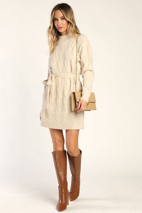 Bundling up for the season has never looked so fabulous thanks to the Lulus Warmed Up To You Cream Cable Knit Mock Neck Sweater Dress! Thick, cozy wool-blend cable knit shapes a mock neckline, long sleeves, and a relaxed bodice. The shift silhouette falls to a cute mini hem and features a tying belt that allows you to cinch the waist. Contrasting ribbed knit accents the neckline, cuffs, and hem. Fit: This garment fits true to size. Length: Mid-thigh. Size medium measures 32.5" from shoulder to h Neutral Sweater Dress, White Sweater Dress With Tights, Cream Holiday Outfit, Winter Picture Outfits, Graduation Dress Winter, Bridal Shower Guest Outfit Winter, Cream Sweater Dress Outfit, Fall Dress Outfit With Boots, Winter Photoshoot Outfits