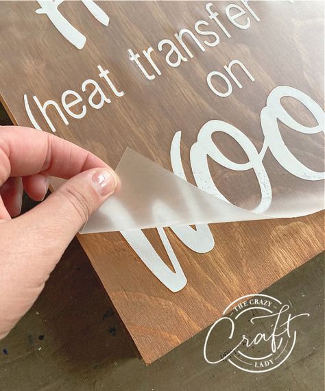 peeling away the HTV backing when using vinyl on wood Diy Sayings On Wood, Making Wood Signs With Cricut, Vinyl Lettering On Wood, Iron On Wood Cricut, How To Put Vinyl On Wood, Cricut Home Signs Diy, Words On Wood Signs Diy, Cricuit Ideas Diy Projects Wood, Heat Transfer Vinyl On Wood